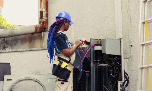 Competent mechanic starting routine condenser maintenance, assembling set of ac gauges vacuum pumps. Trained professional reading pressure of liquids and gases in hvac system